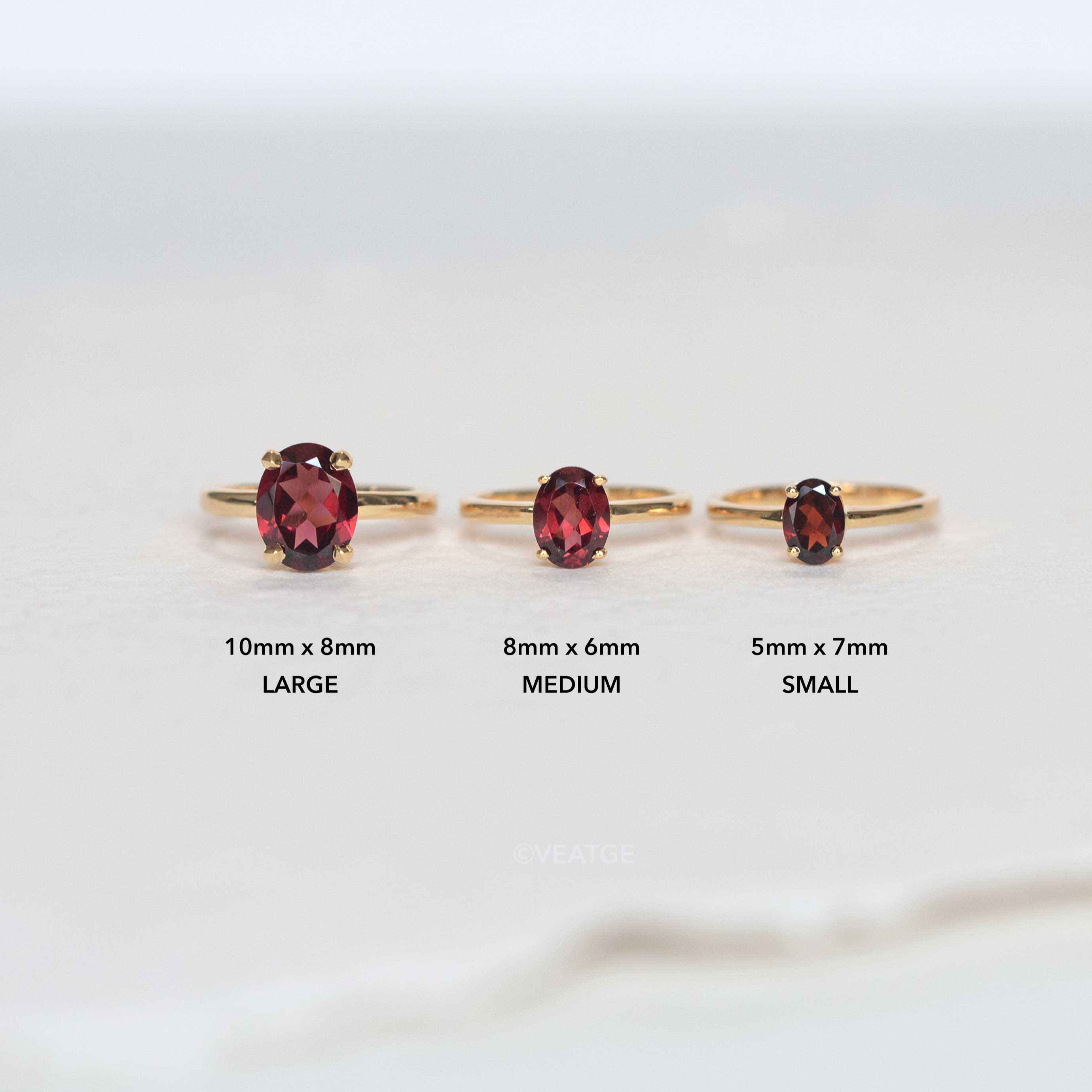 Three garnet gemstone rings set in 18k gold vermeil on 925 silver, with different sizes, displayed against a light background.