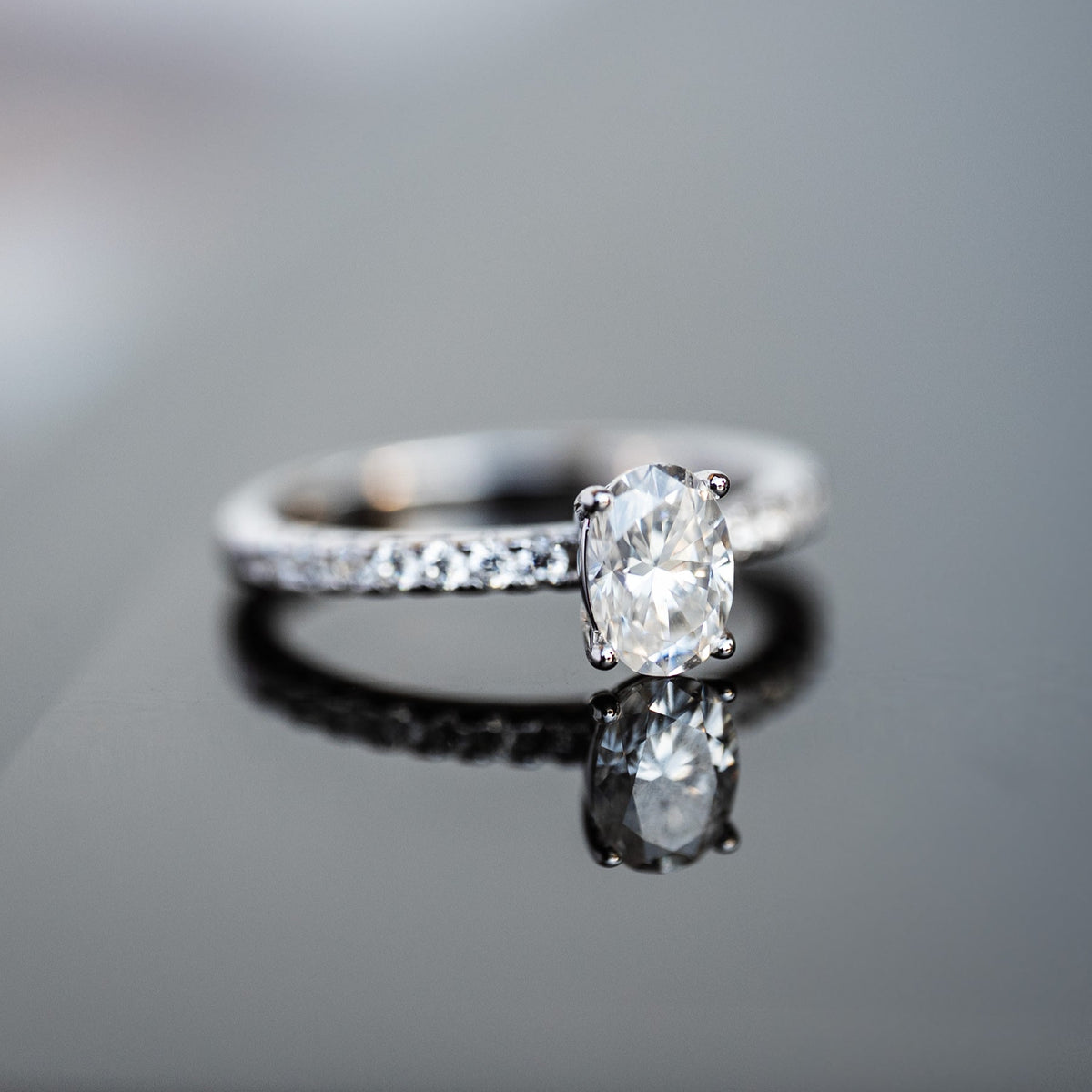 Diamond ring on a reflective surface with a blurred background