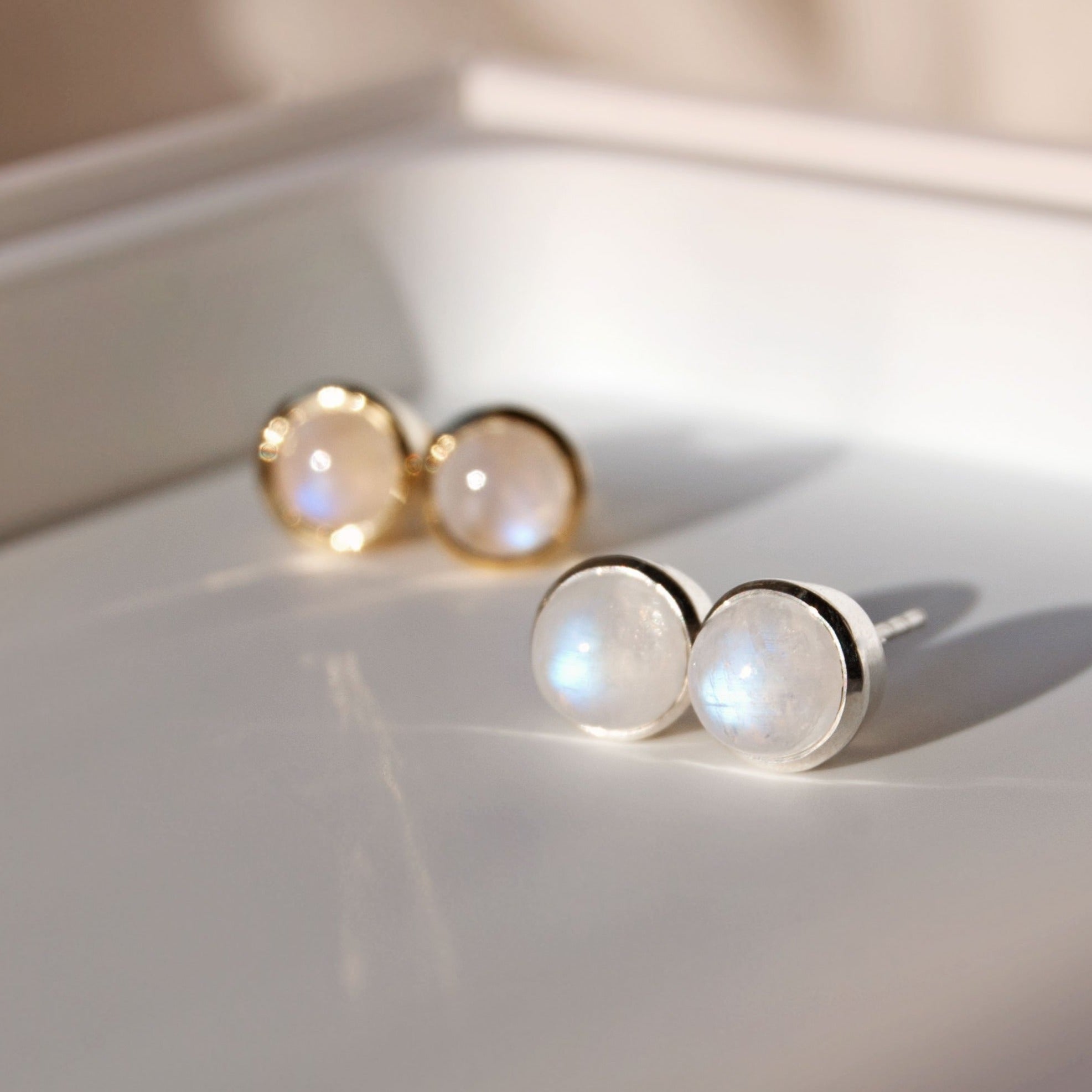 moonstone stud earrings in silver and gold
